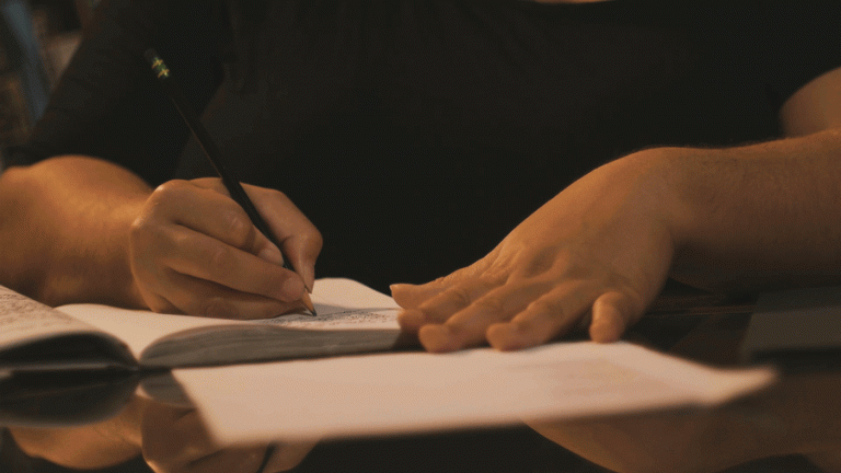 Animated G-I-F of a person writing in a notebook