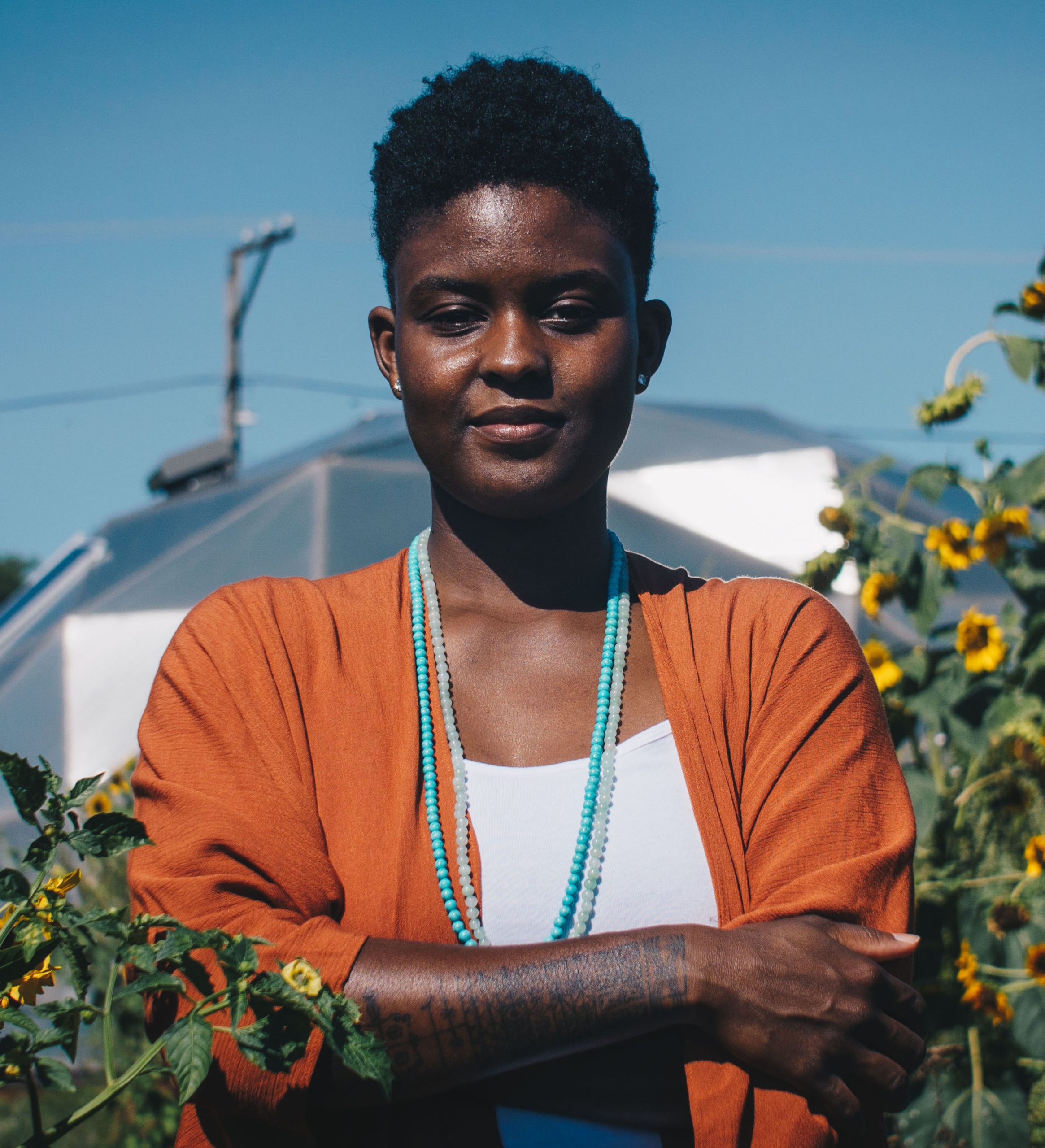 Alexandra Antoine standing in an urban garden
